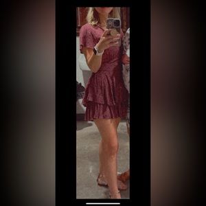 Maroon frilly short romper. Zip and tie in back. Altar’d state.